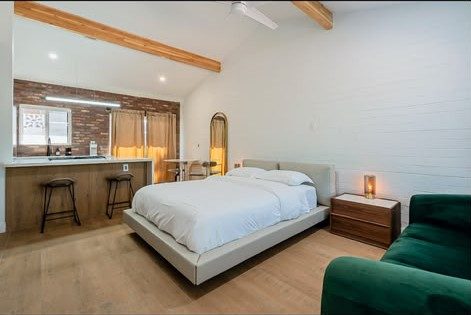 Suite bedroom with emerald velvet seating at Second Sunrise Recovery